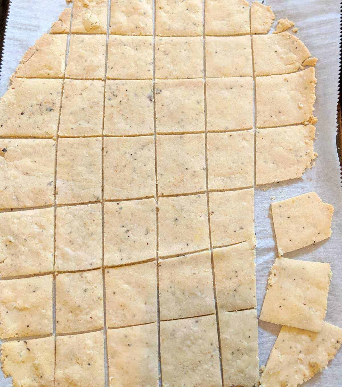Overhead view of baked cracker sheet cut into individual crackers.
