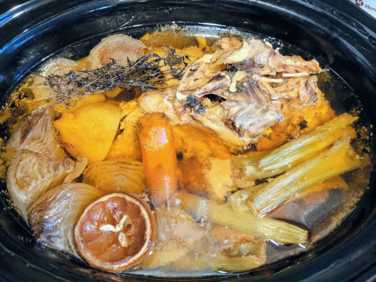 Cooked bones and vegetables in the crockpot.