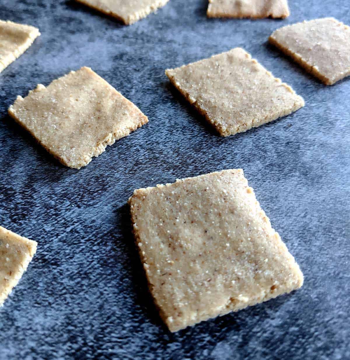 Tigernut flour crackers on a blue surface.