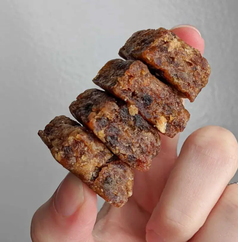 stack of 4 apricot protein bites held between two fingers