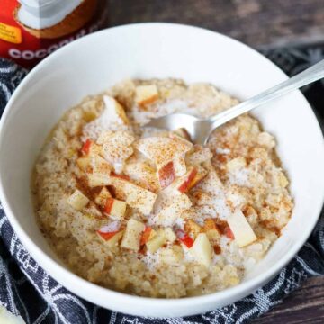 Apple noatmeal in a white bowl with a spoon.