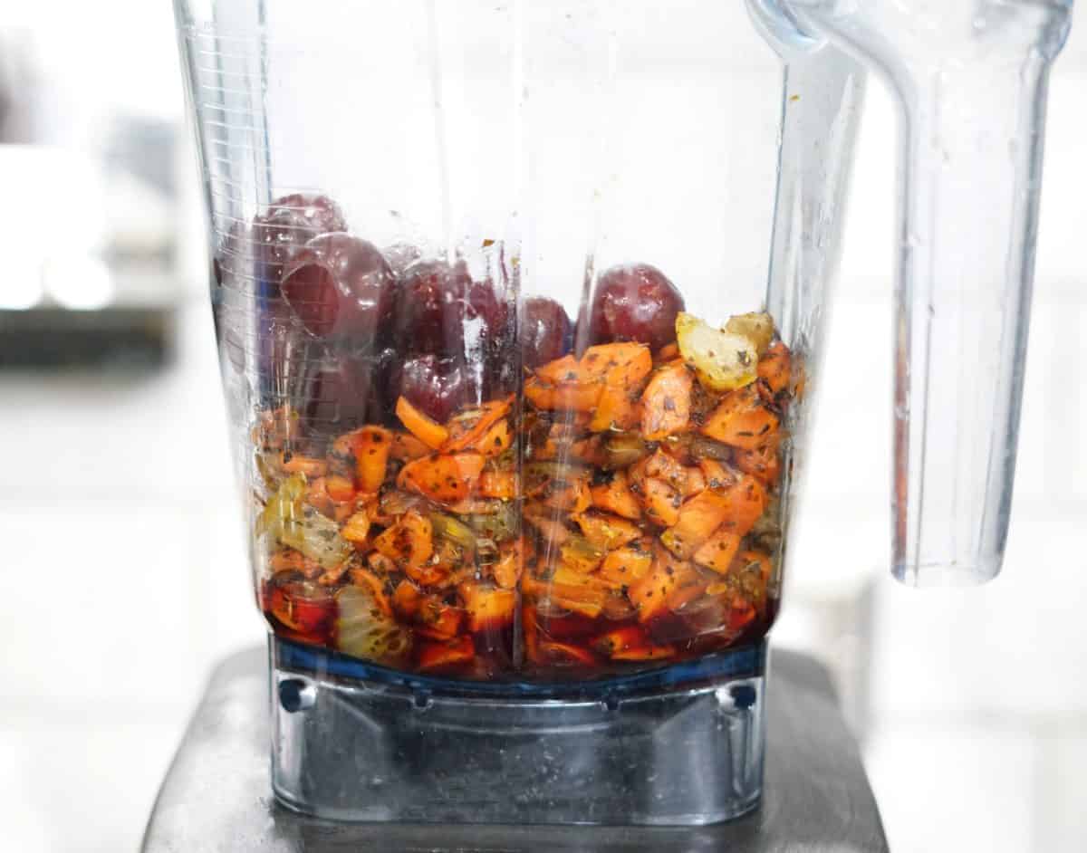 carrots, onions, and cherries in a blender.